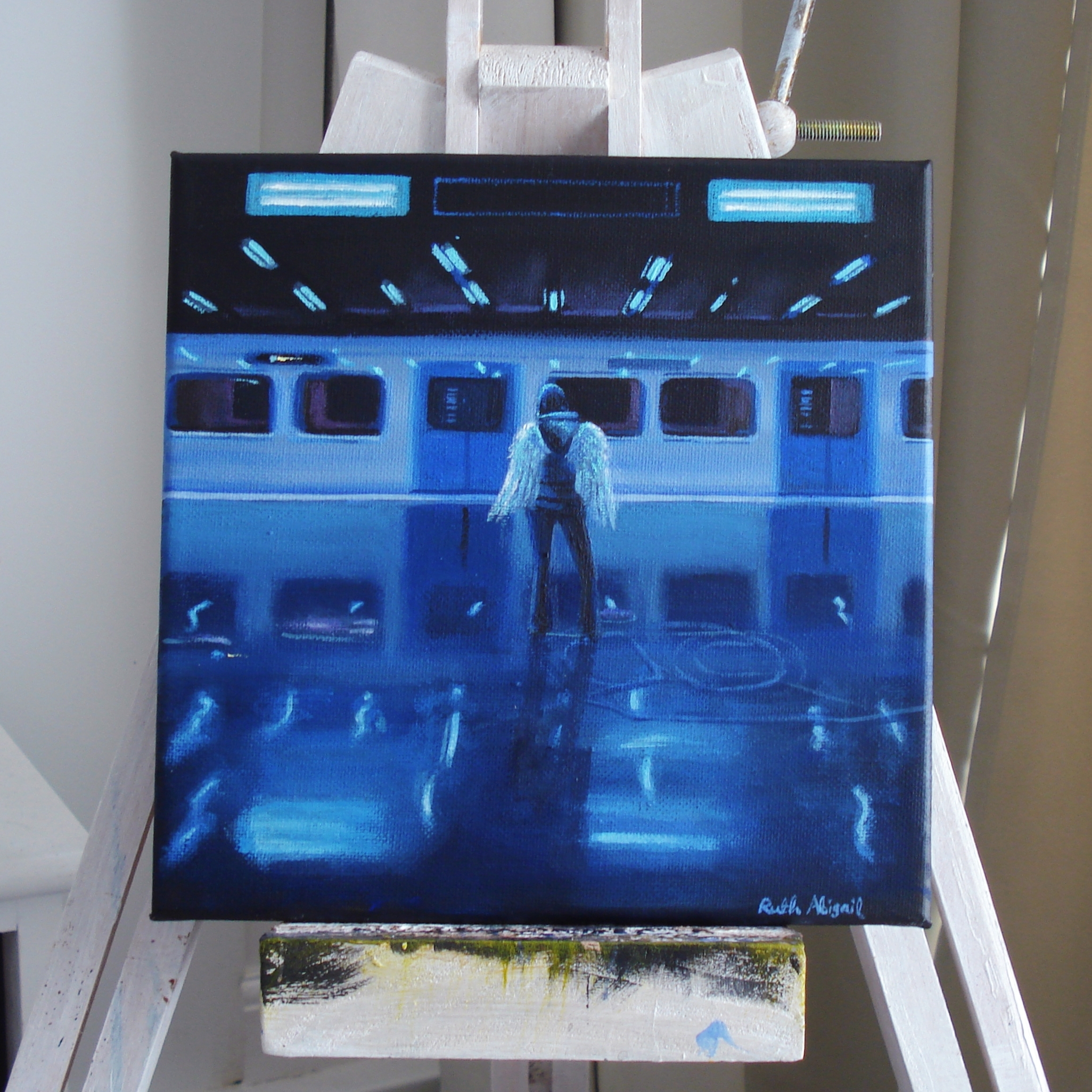 Available painting of a winged figure standing before a blue-lit train